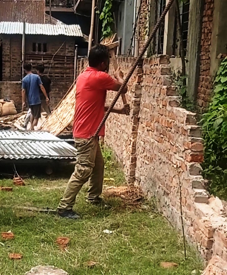 Workers removing the illegal structures at DPRO Dimapur office compound on May 18. (DIPR Photo)